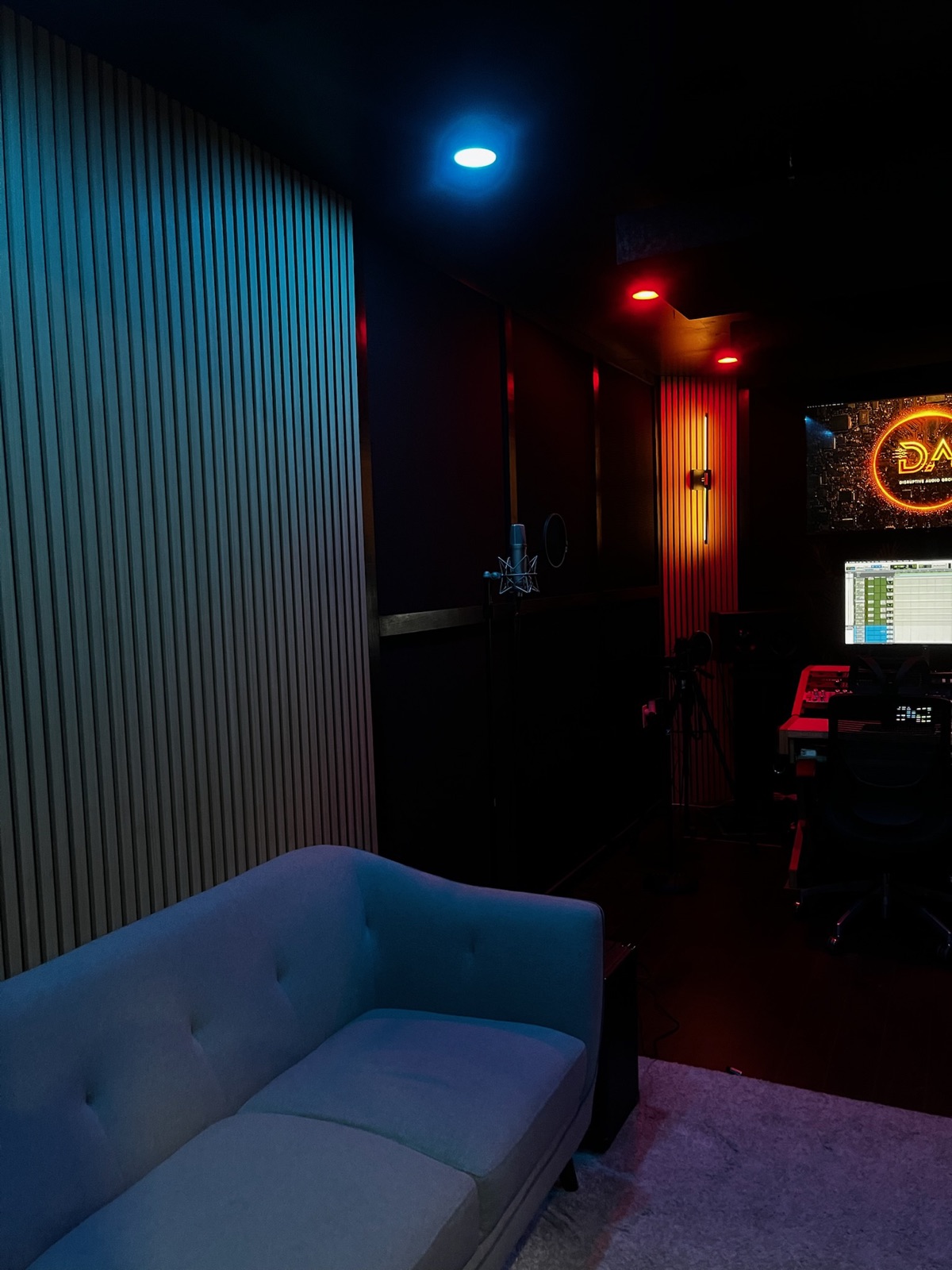 The lounge, with wood-slat acoustic walls and the vocal mic in the background
