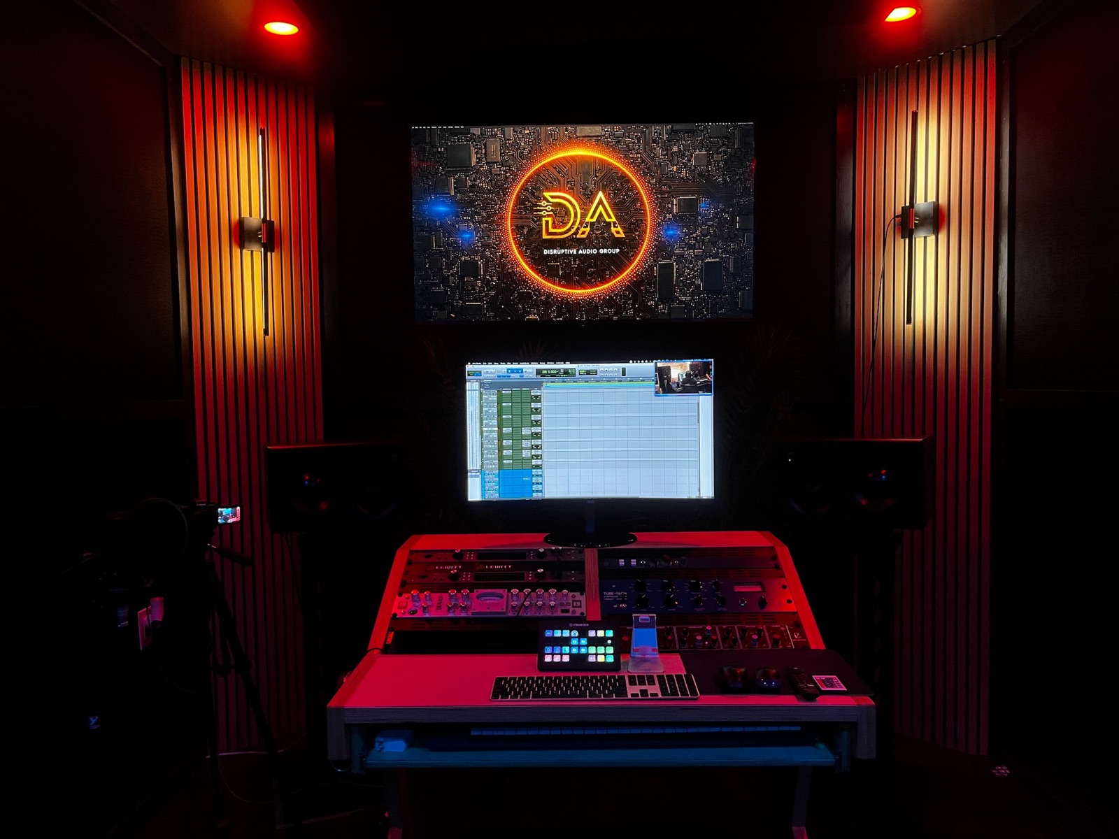 The main mixing desk with the Disruptive Audio Group logo on the screen