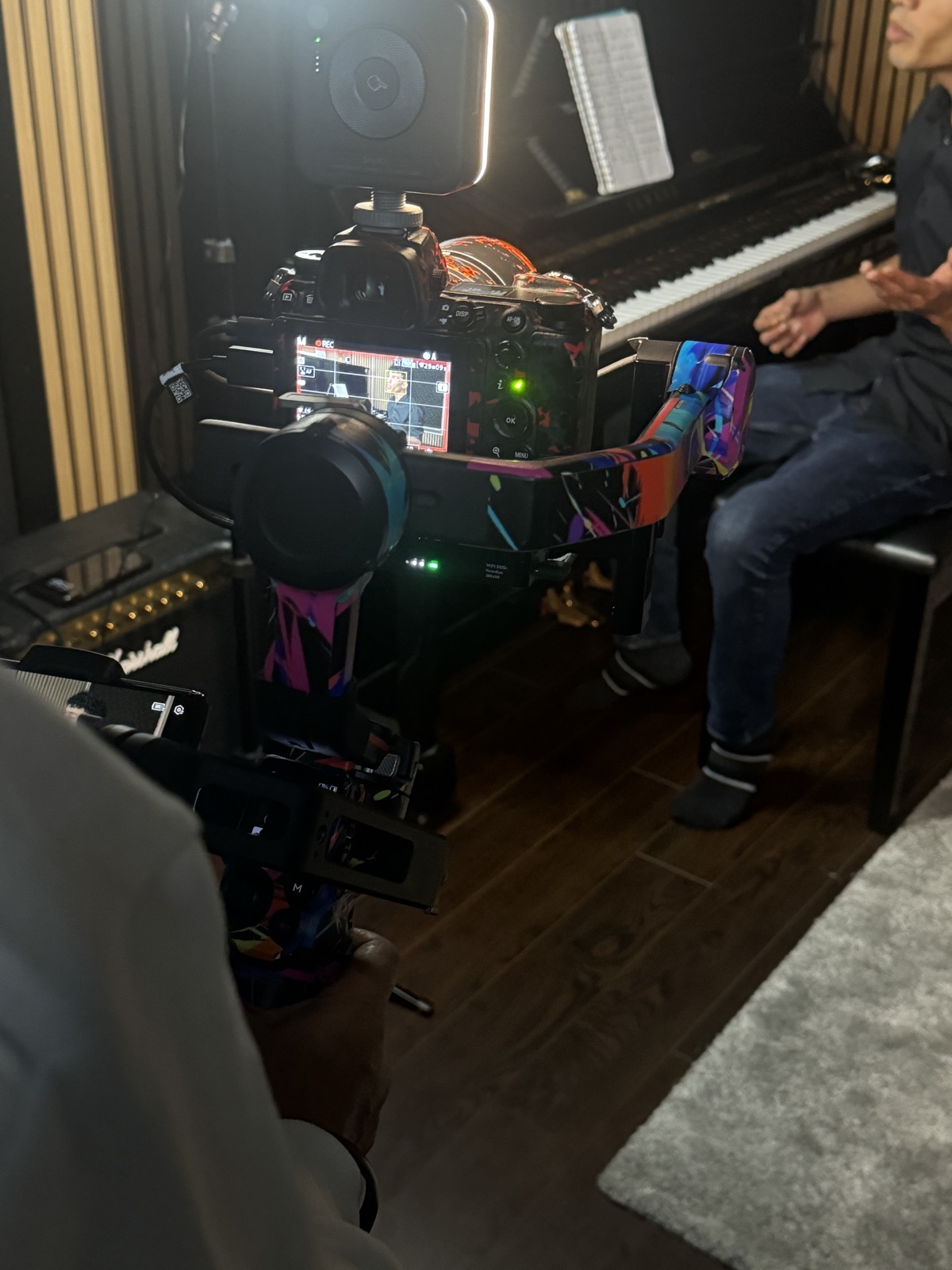 Behind the scenes of a video shoot at the piano